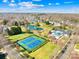 Aerial view of community amenities, including tennis courts, a pond, pool, and clubhouse in a neighborhood setting at 9433 Gilpatrick Ln, Huntersville, NC 28078