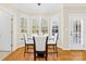 Dining area filled with natural light, showcasing plantation shutters and a modern chandelier at 9433 Gilpatrick Ln, Huntersville, NC 28078