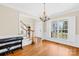 Dining room showcasing hardwood floors, white wainscoting, and natural light from a large window at 9433 Gilpatrick Ln, Huntersville, NC 28078