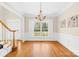 Elegant dining room featuring hardwood floors, wainscoting, and a chandelier fixture at 9433 Gilpatrick Ln, Huntersville, NC 28078