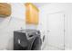 Laundry room with modern appliances, white walls, storage shelves, and a bright white door at 9433 Gilpatrick Ln, Huntersville, NC 28078