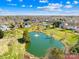 Picturesque pond with a fountain, set against a backdrop of lush greenery and neighborhood homes at 9433 Gilpatrick Ln, Huntersville, NC 28078