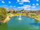 Beautiful pond view with a fountain, surrounded by mature trees and landscaping near the home at 9433 Gilpatrick Ln, Huntersville, NC 28078