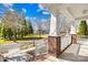 Covered front porch with white railing and brick columns, offering a welcoming entrance at 9433 Gilpatrick Ln, Huntersville, NC 28078