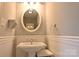 Charming bathroom with a pedestal sink, wainscoting, and an oval mirror at 1020 Saint Paul Church Rd, Clover, SC 29710