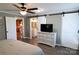 Open bedroom with sliding barn doors, modern dresser, and views of the kitchen and bathroom at 1020 Saint Paul Church Rd, Clover, SC 29710