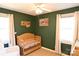 Charming Bedroom with wooden crib, green walls, and natural light from two windows at 1020 Saint Paul Church Rd, Clover, SC 29710
