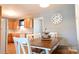 Inviting dining area with wood table, white chairs, and kitchen view at 1020 Saint Paul Church Rd, Clover, SC 29710