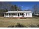 Charming one-story home boasts a covered front porch, tidy landscaping, and a convenient carport at 1020 Saint Paul Church Rd, Clover, SC 29710