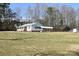 The house has a front porch, carport and shed surrounded by a large open grass yard at 1020 Saint Paul Church Rd, Clover, SC 29710