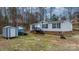 Cozy home featuring vinyl siding, a brick foundation, a useful shed, and convenient front stairs at 109 Dogwood Dr, Hickory, NC 28601