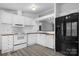 Charming kitchen with white cabinetry, butcher block countertops and modern black appliances at 109 Dogwood Dr, Hickory, NC 28601