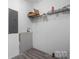 Laundry room with white walls, wood-look floor, and shelving for organization at 109 Dogwood Dr, Hickory, NC 28601