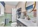 Quaint bathroom with a green color scheme, a vanity with gold fixtures and a circular mirror at 1101 Roundknob Ave, Salisbury, NC 28144