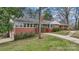Charming brick home with a walkway leading to the front door, surrounded by well-maintained landscaping and mature trees at 1101 Roundknob Ave, Salisbury, NC 28144