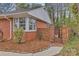 Brick home showcasing an iron gate entrance with decorative shrubbery, creating curb appeal and privacy at 1101 Roundknob Ave, Salisbury, NC 28144