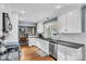 Bright kitchen featuring white cabinets, black granite countertops, stainless steel appliances, and hardwood flooring at 1101 Roundknob Ave, Salisbury, NC 28144