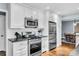 Well-lit kitchen featuring stainless steel appliances, white subway tile backsplash, and hardwood flooring at 1101 Roundknob Ave, Salisbury, NC 28144