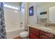 Cozy bathroom with granite countertops, a cherry-wood vanity, and a tub with shower at 11243 Home Place Ln, Mint Hill, NC 28227