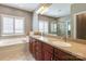 Bathroom with double sink vanity, bathtub, window and separate shower with glass enclosure at 11243 Home Place Ln, Mint Hill, NC 28227