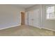 This bedroom has neutral walls and plush carpeting, a perfect canvas at 11243 Home Place Ln, Mint Hill, NC 28227