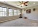 Spacious and sunny bonus room with lots of natural light from the large windows and carpeted flooring at 11243 Home Place Ln, Mint Hill, NC 28227
