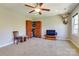 Spacious bonus room featuring a ceiling fan, built-in shelving, and neutral carpet flooring at 11243 Home Place Ln, Mint Hill, NC 28227