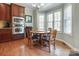 Cozy breakfast nook with wood floors and cabinetry with stainless steel oven and natural light from bright windows at 11243 Home Place Ln, Mint Hill, NC 28227