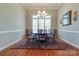 Elegant dining room featuring hardwood floors, a chandelier, and seating for six around a dark wood table at 11243 Home Place Ln, Mint Hill, NC 28227