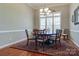 Elegant dining room featuring hardwood floors, a chandelier, and seating for six around a dark wood table at 11243 Home Place Ln, Mint Hill, NC 28227