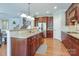 Open kitchen design features a kitchen island with granite countertop, stainless appliances and hardwood flooring at 11243 Home Place Ln, Mint Hill, NC 28227