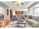 Open-concept living room that features hardwood floors and flows into the kitchen and dining areas at 11243 Home Place Ln, Mint Hill, NC 28227