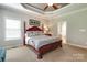 Tranquil main bedroom boasts tray ceilings, a ceiling fan, a spacious layout, and ensuite bathroom at 11243 Home Place Ln, Mint Hill, NC 28227
