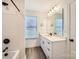 Bathroom featuring a tub, shower, and vanity with matte black accents at 117 Mountain View St, Gastonia, NC 28052