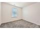 Bright bedroom features a neutral color palette, plush carpeting, and natural light at 117 Mountain View St, Gastonia, NC 28052