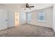 Large carpeted bedroom features two windows and access to the bathroom at 117 Mountain View St, Gastonia, NC 28052