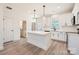 Modern kitchen features white cabinetry, an island, and stainless steel appliances at 117 Mountain View St, Gastonia, NC 28052