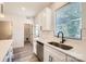 Galley kitchen has stainless steel appliances, modern sink, and quartz countertops at 117 Mountain View St, Gastonia, NC 28052