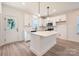 Bright kitchen with white cabinets, central island, and stainless steel appliances at 117 Mountain View St, Gastonia, NC 28052