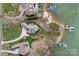Stunning aerial view showcasing the property, its lush landscaping, private boat docks, and waterfront access at 130 Brick Kiln Way, Mooresville, NC 28117