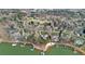 Aerial view of lakefront homes with private docks nestled in a serene wooded landscape at 130 Brick Kiln Way, Mooresville, NC 28117