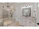 Bright bathroom featuring a glass shower and granite countertop vanity at 130 Brick Kiln Way, Mooresville, NC 28117