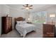 Comfortable bedroom with a large window, a plush carpet, and dark wood furniture at 130 Brick Kiln Way, Mooresville, NC 28117