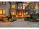 Elegant home exterior with stone and brick, arched entryway, and landscaped front yard at 130 Brick Kiln Way, Mooresville, NC 28117
