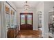 Inviting front entrance with decorative glass doors, hardwood floors, and stylish lighting at 130 Brick Kiln Way, Mooresville, NC 28117