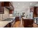 Gourmet kitchen featuring stainless steel appliances, granite countertops, and a large island at 130 Brick Kiln Way, Mooresville, NC 28117