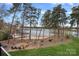 Breathtaking lake view featuring a private beach, fire pit, and mature trees creating a serene and inviting outdoor space at 130 Brick Kiln Way, Mooresville, NC 28117
