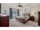 Spacious main bedroom with tray ceiling, lake view window, and en-suite bathroom at 130 Brick Kiln Way, Mooresville, NC 28117