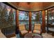 Relaxing sunroom with seating and panoramic views of the lake at 130 Brick Kiln Way, Mooresville, NC 28117