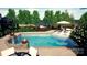 Swimming pool area with lounge chairs, lush landscaping, and a tranquil atmosphere at 130 Brick Kiln Way, Mooresville, NC 28117